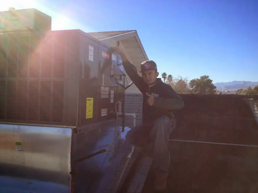 HVAC technician performing HVAC Inspection on a rooftop unit in Upper Providence